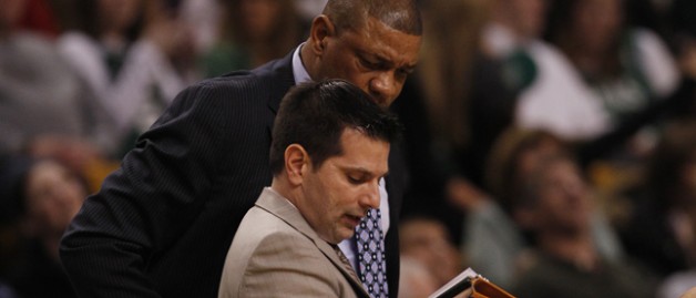 Boston Celtics head coach Doc Rivers tlooks over the shoulder of assistant coach Mike Longabardi during the second half of an NBA basketball game in Boston, Friday, Jan. 4, 2013. The Celtics beat the Pacers 94-75. (AP Photo/Charles Krupa)
