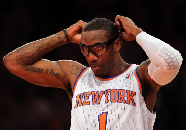 NEW YORK, NY - JANUARY 01: Amar'e Stoudemire #1 of the New York Knicks adjusts his glasses in the first quarter against the Portland Trail Blazers on January 1, 2013 at Madison Square Garden in New York City. NOTE TO USER: User expressly acknowledges and agrees that, by downloading and/or using this photograph, user is consenting to the terms and conditions of the Getty Images License Agreement. (Photo by Elsa/Getty Images)